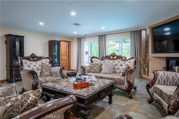a living room with furniture fireplace and flat screen tv
