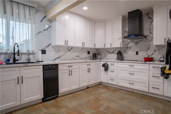 a kitchen with cabinets appliances and a sink