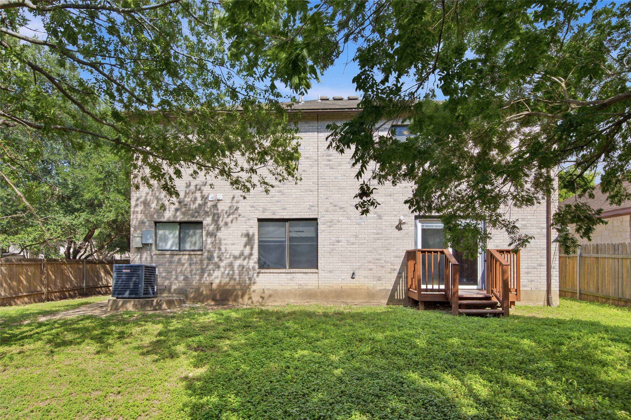 7900 Rosenberry Drive Austin, TX 78747 - Photo 25 of 27 A well-maintained brick exterior with a wood deck and a fenced yard for privacy.