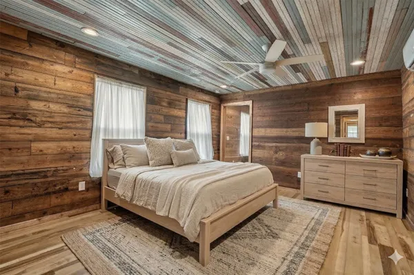 a bedroom with a large bed and a dresser