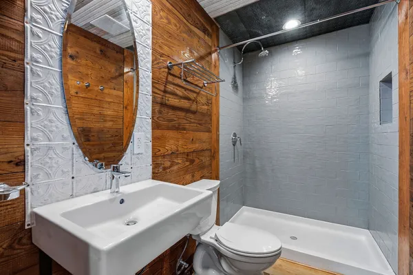 a bathroom with a sink toilet and shower
