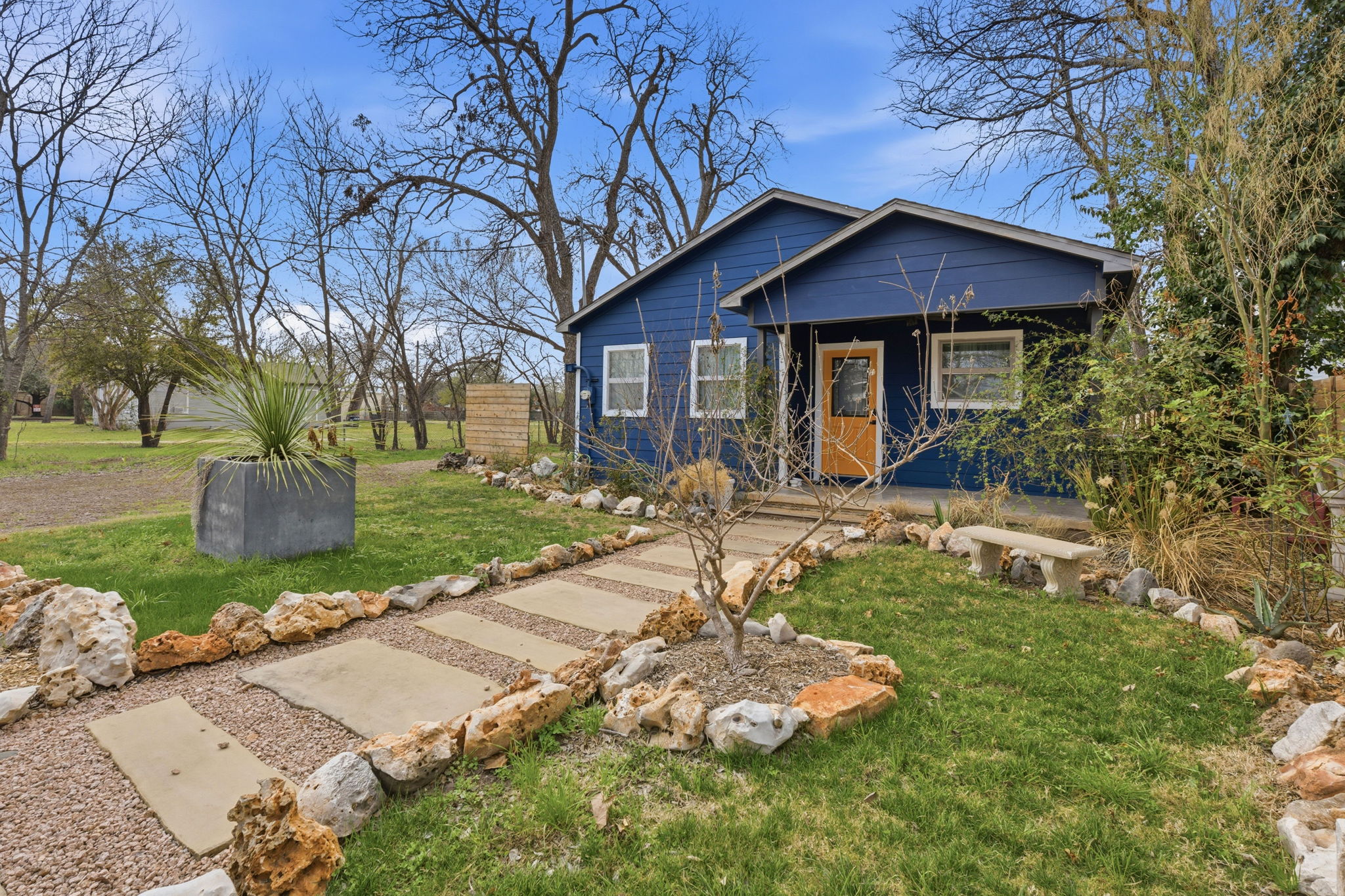 1148 Gunter Street Austin, TX 78721 - Photo 2 of 18 a front view of a house with garden