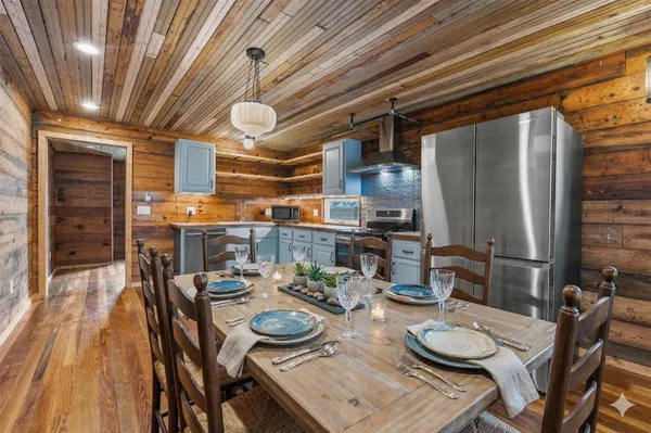 a dining room with furniture and wooden floor