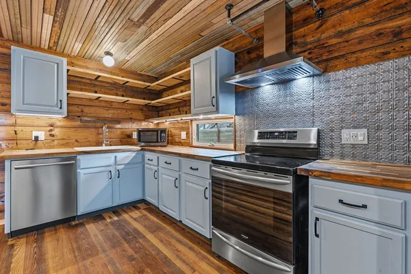 a kitchen with a stove microwave and cabinets