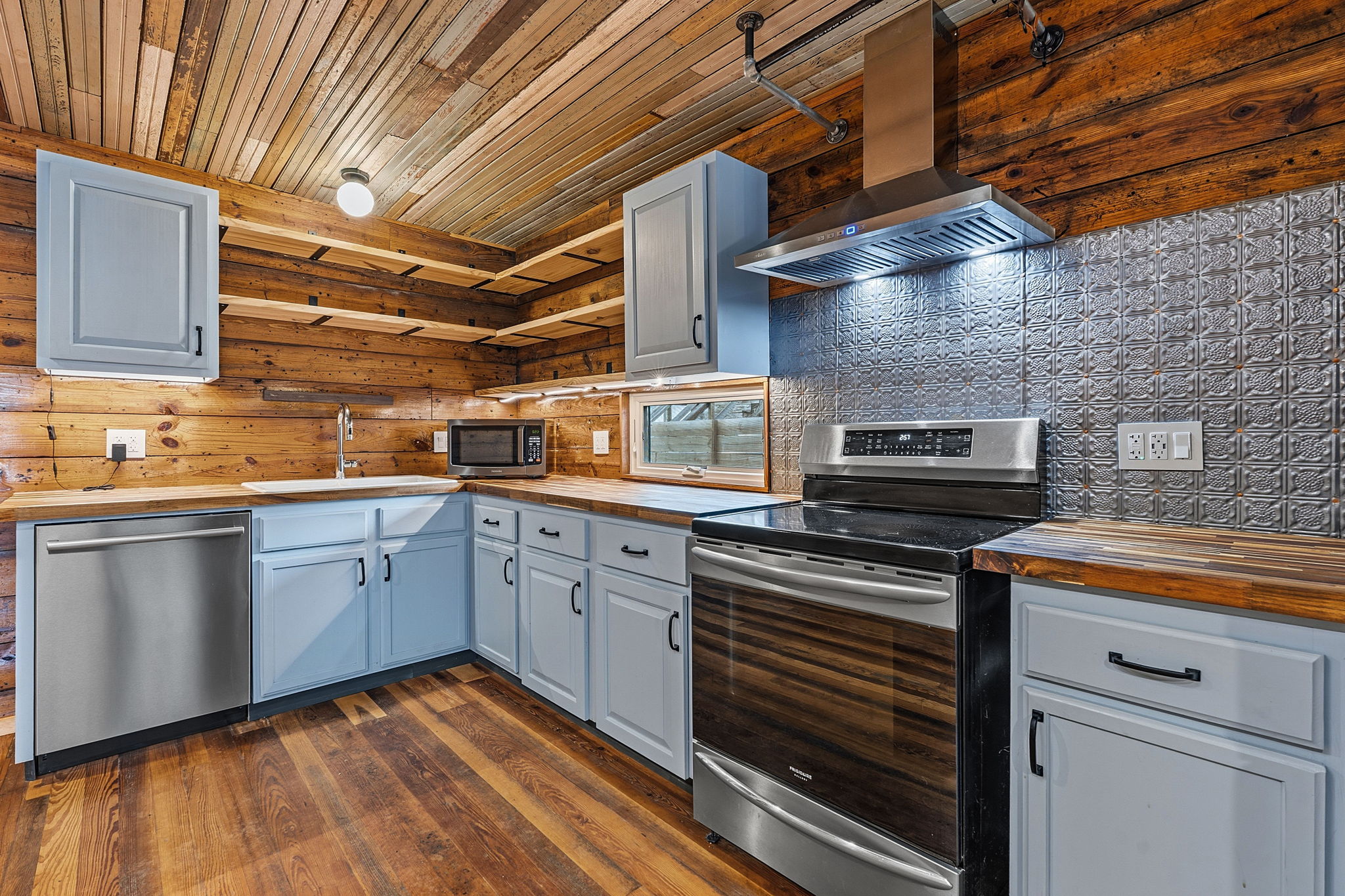 1148 Gunter Street Austin, TX 78721 - Photo 7 of 18 a kitchen with a stove microwave and cabinets