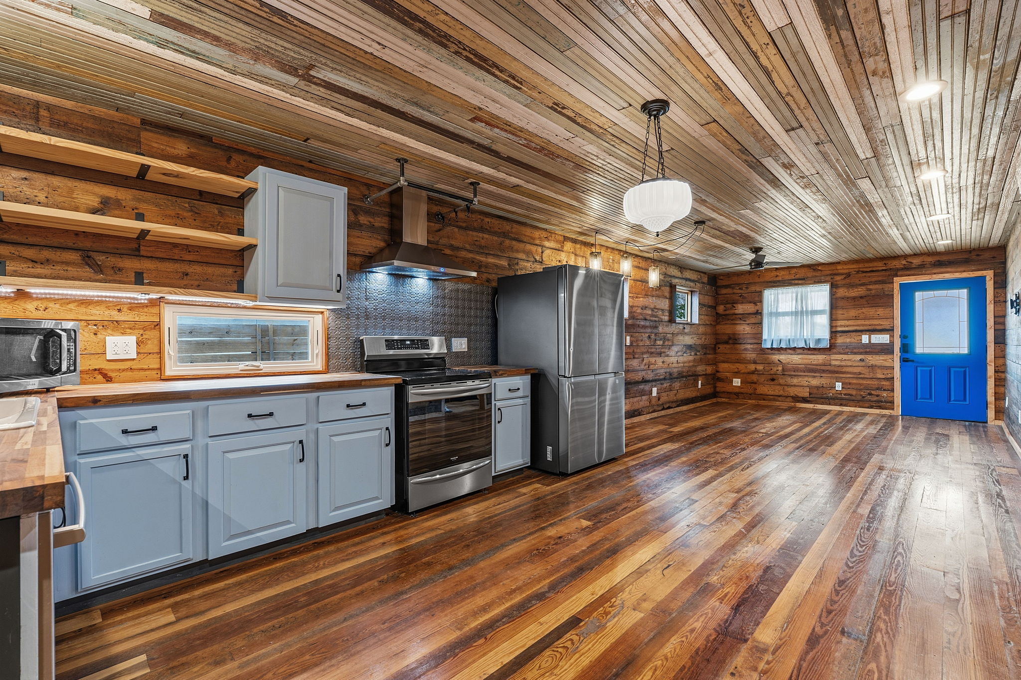 1148 Gunter Street Austin, TX 78721 - Photo 8 of 18 a kitchen with stainless steel appliances granite countertop a sink cabinets and wooden floor