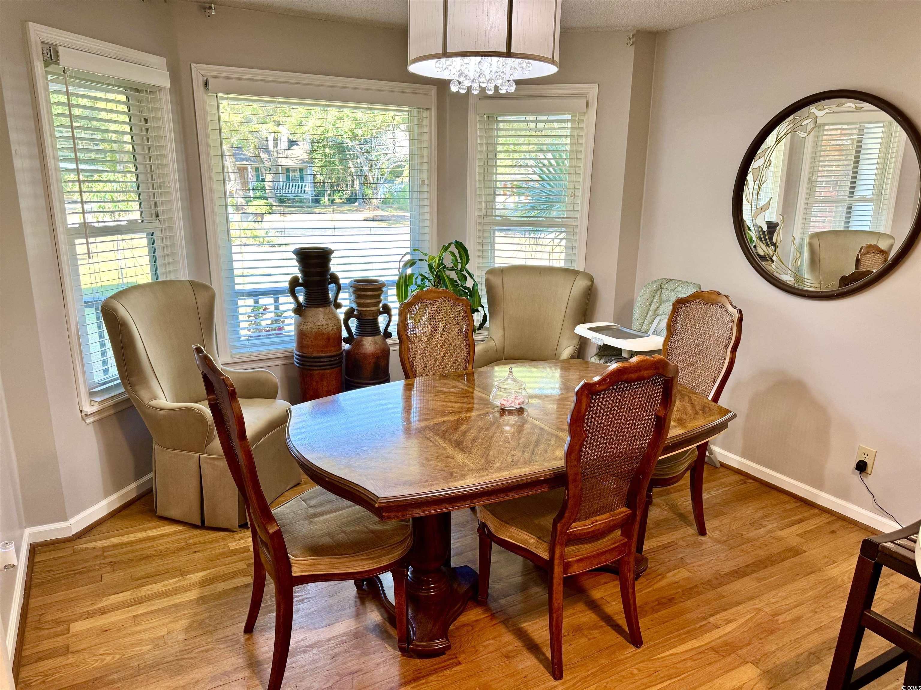 40 Governor Boone Lane Georgetown, SC 29440 - Photo 5 of 33 Dining area featuring light wood-style flooring and a textured ceiling
