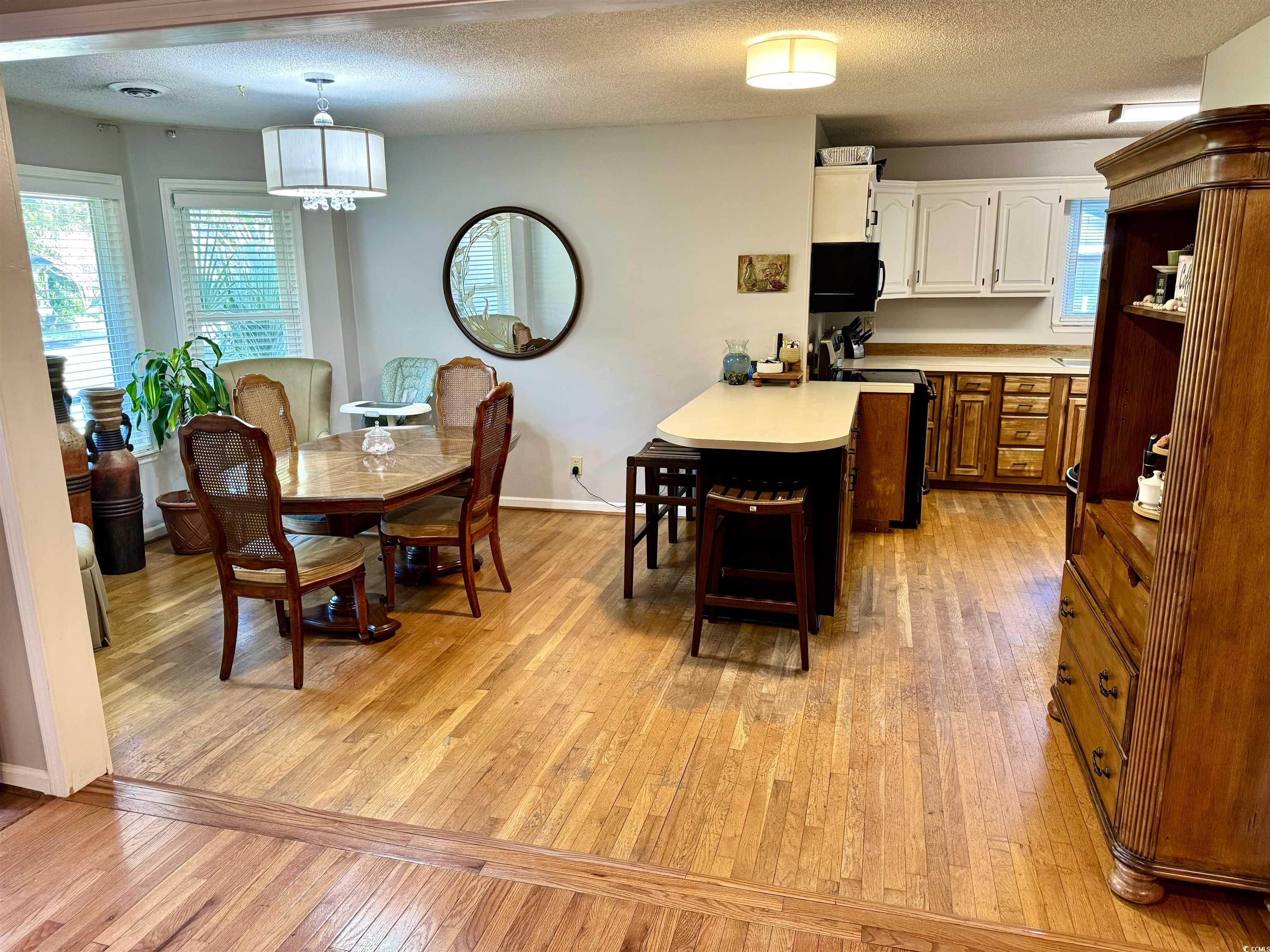 40 Governor Boone Lane Georgetown, SC 29440 - Photo 6 of 33 Dining room featuring light wood-style flooring and a textured ceiling