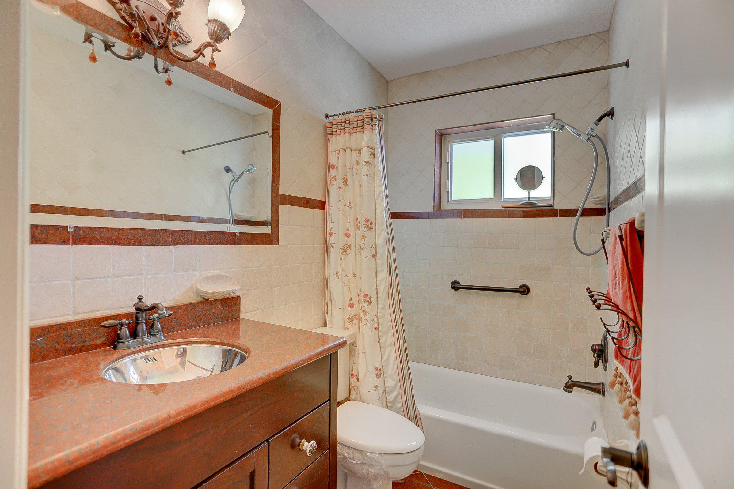 6520 North Ocean Boulevard, Unit 28 Ocean Ridge, FL 33435 - Photo 12 of 32 a bathroom with a sink toilet tub and shower