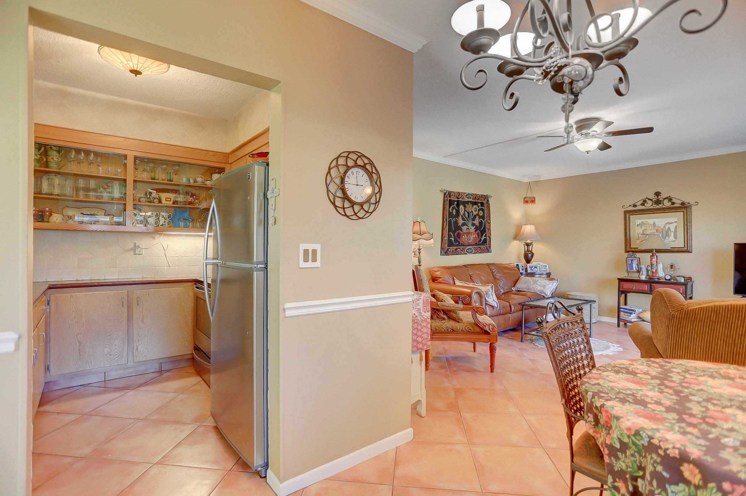 6520 North Ocean Boulevard, Unit 28 Ocean Ridge, FL 33435 - Photo 16 of 32 a view of a livingroom with furniture a chandelier and wooden floor