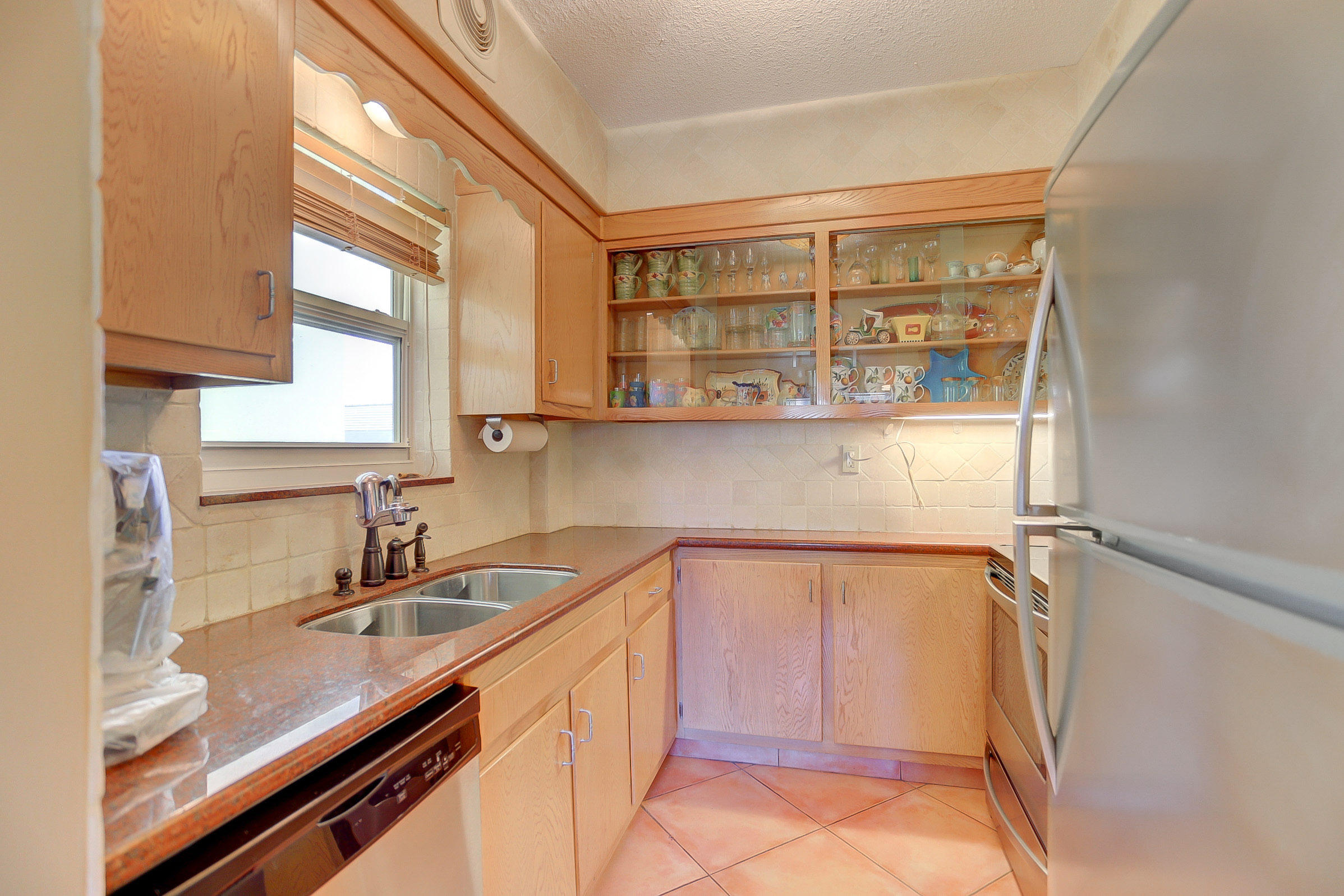 6520 North Ocean Boulevard, Unit 28 Ocean Ridge, FL 33435 - Photo 17 of 32 a kitchen with a sink and a refrigerator