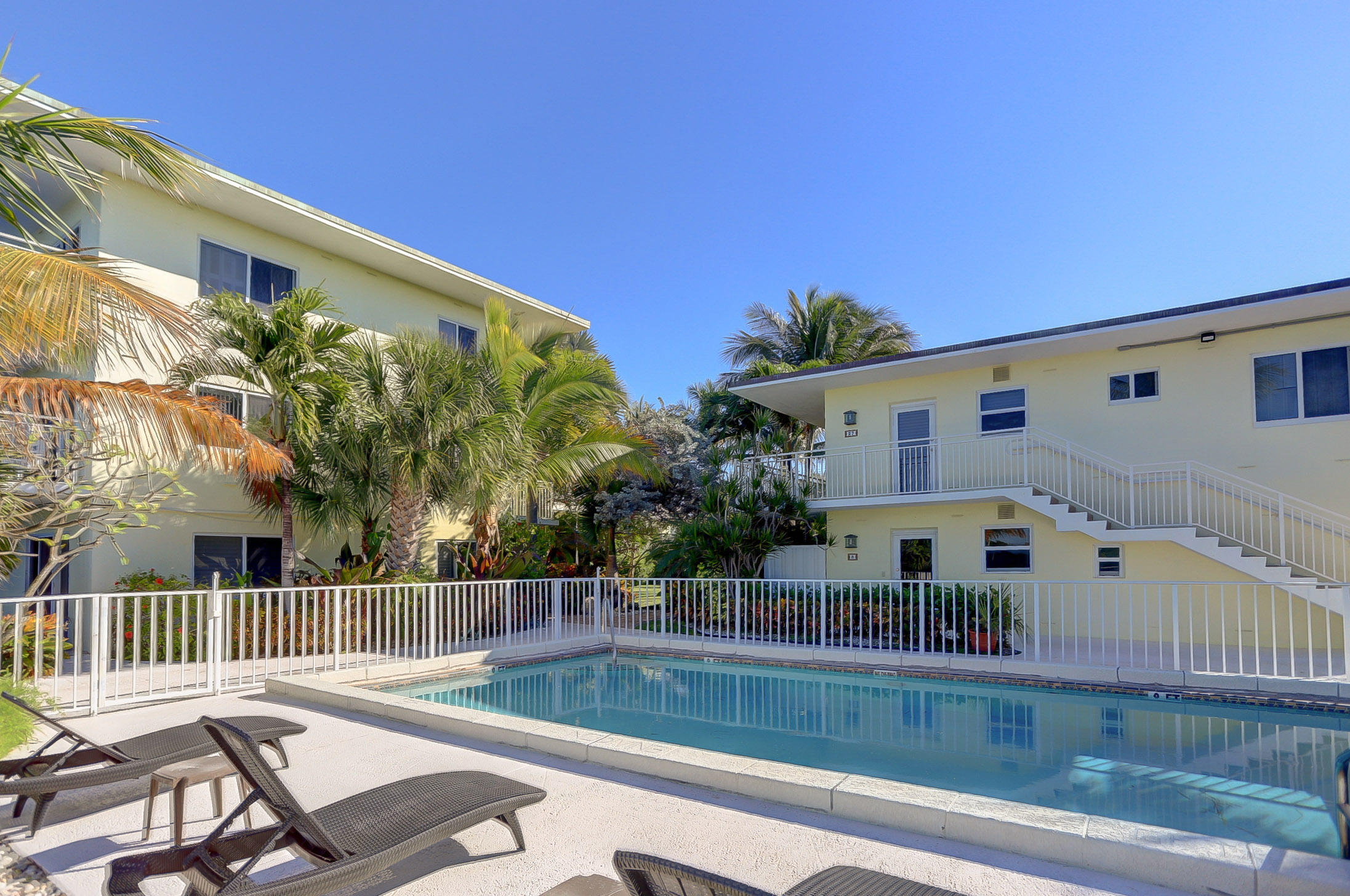 6520 North Ocean Boulevard, Unit 28 Ocean Ridge, FL 33435 - Photo 22 of 32 a view of a chair and tables in the balcony