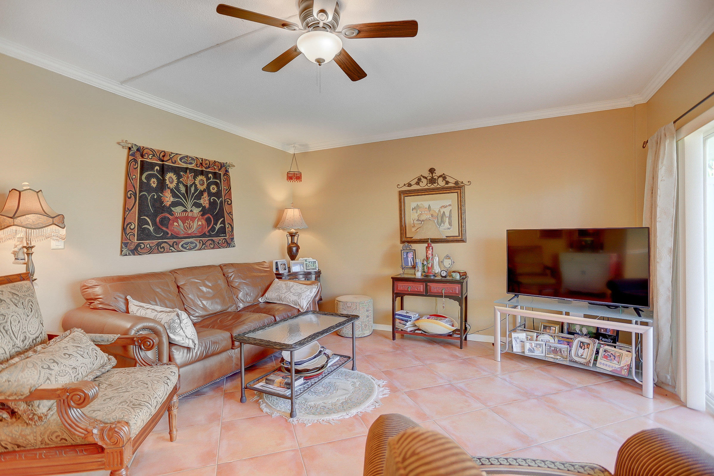 6520 North Ocean Boulevard, Unit 28 Ocean Ridge, FL 33435 - Photo 6 of 32 a living room with furniture and a flat screen tv