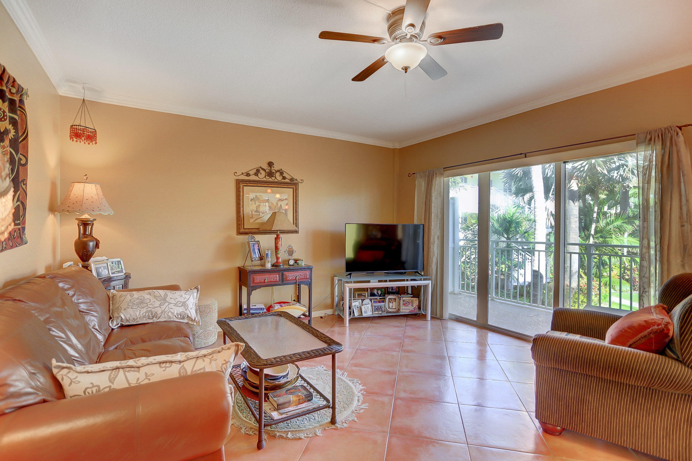6520 North Ocean Boulevard, Unit 28 Ocean Ridge, FL 33435 - Photo 7 of 32 a living room with furniture a flat screen tv and a large window