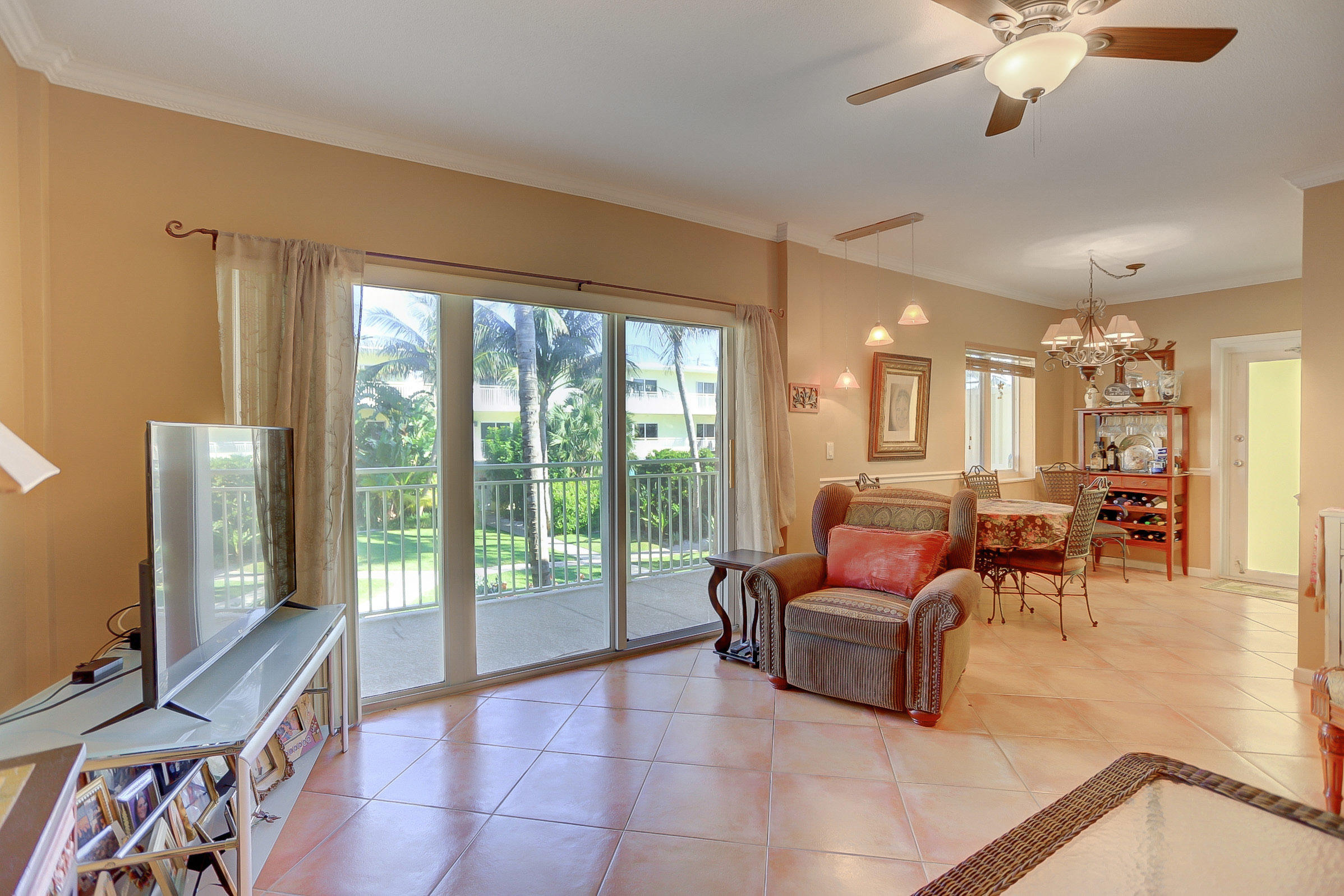 6520 North Ocean Boulevard, Unit 28 Ocean Ridge, FL 33435 - Photo 8 of 32 a living room with furniture and a flat screen tv