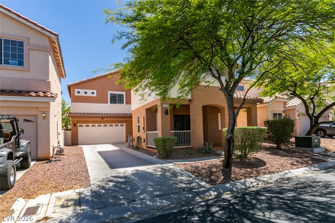 8909 Houston Ridge Avenue Las Vegas, NV 89178 - Photo 21 of 45 A terracotta-hued exterior home with a welcoming arched entry and attached garage.