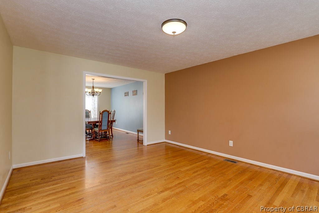 7211 Woody Road Gloucester, VA 23061 - Photo 4 of 24 Large living room with beautiful hardwoods!