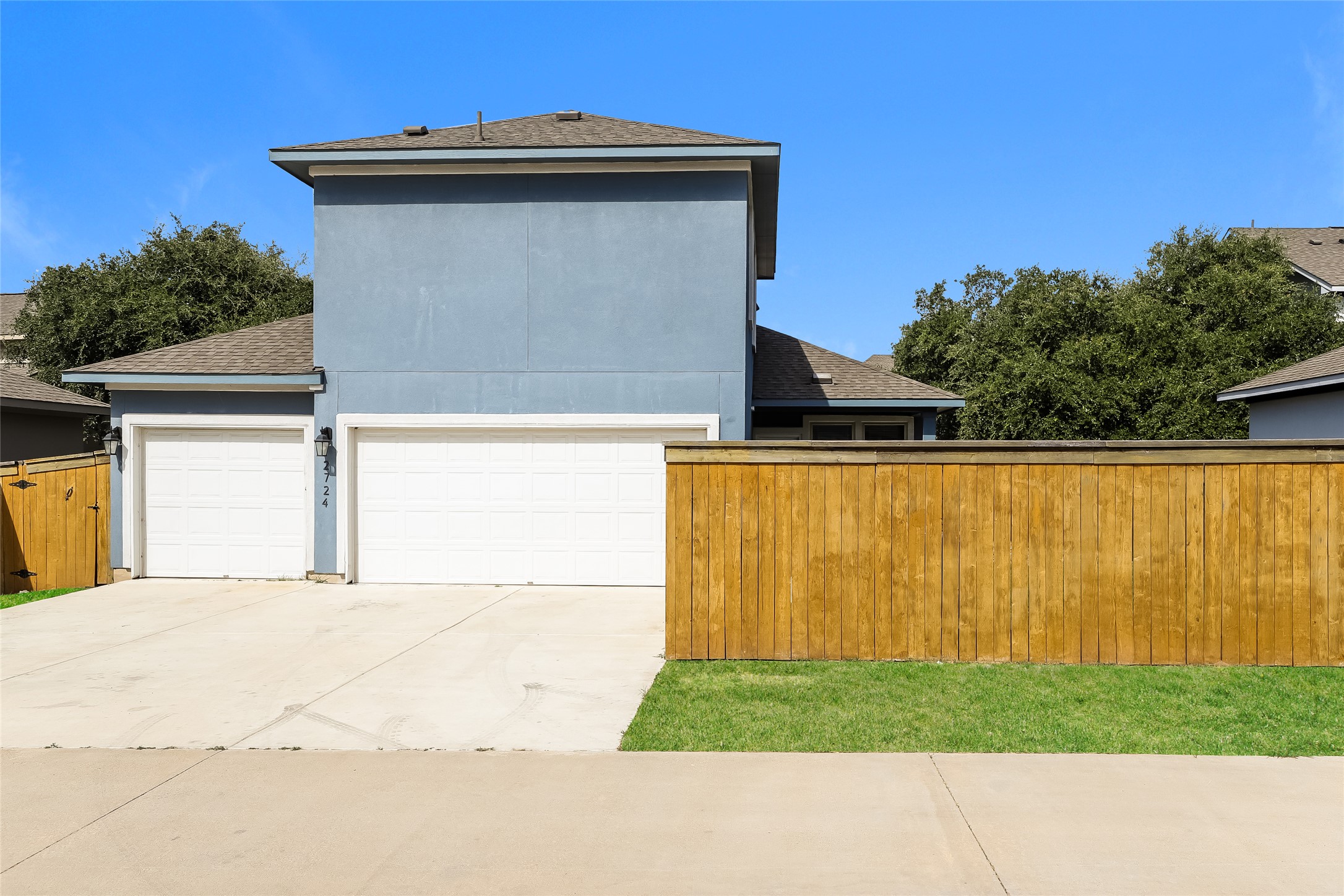 2724 Juniper Woods Road Leander, TX 78641 - Photo 19 of 21 A contemporary residence features a two-car garage and a newly installed privacy fence.