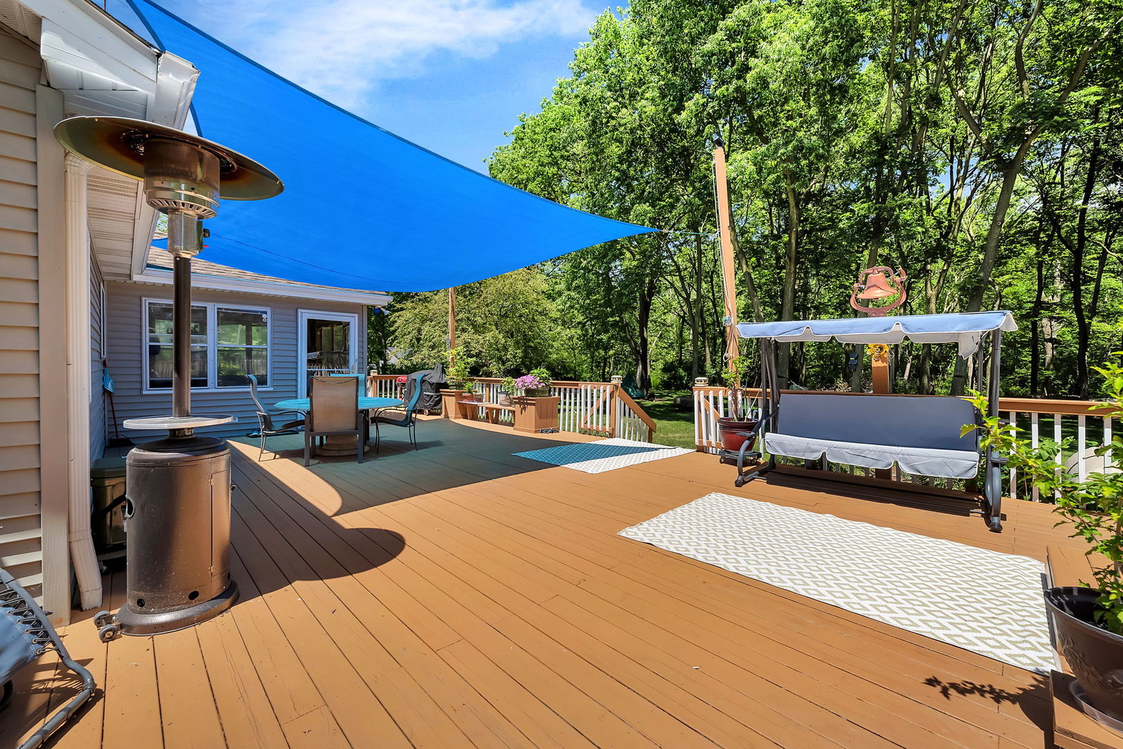 24700 West Canal Road Channahon, IL 60410 - Photo 28 of 30 a view of a patio with couches table and chairs under an umbrella