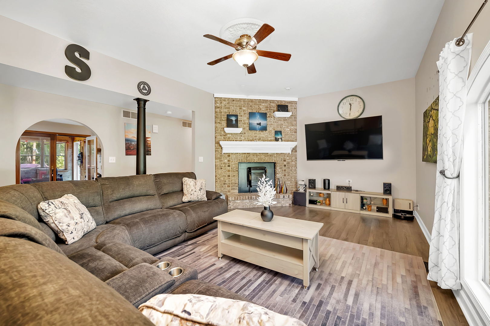 24700 West Canal Road Channahon, IL 60410 - Photo 5 of 30 a living room with furniture a fireplace and a flat screen tv
