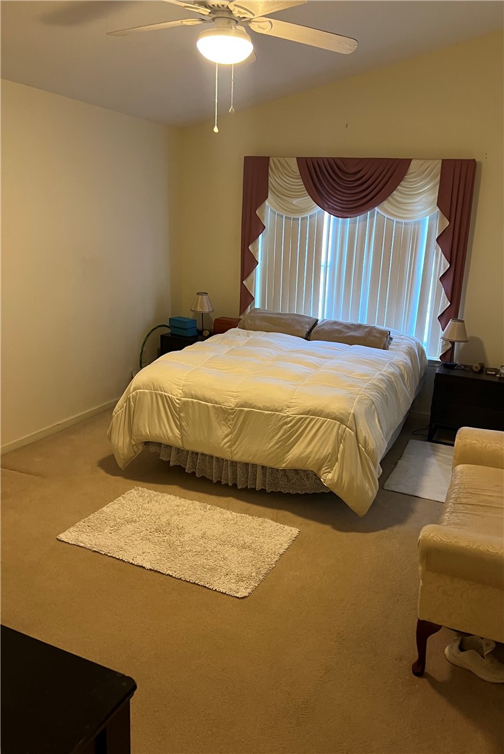 521 Calhoun Shores Parkway Calhoun Falls, SC 29628 - Photo 23 of 39 This cozy bedroom features a ceiling fan, plush carpeting, and elegant window treatments.