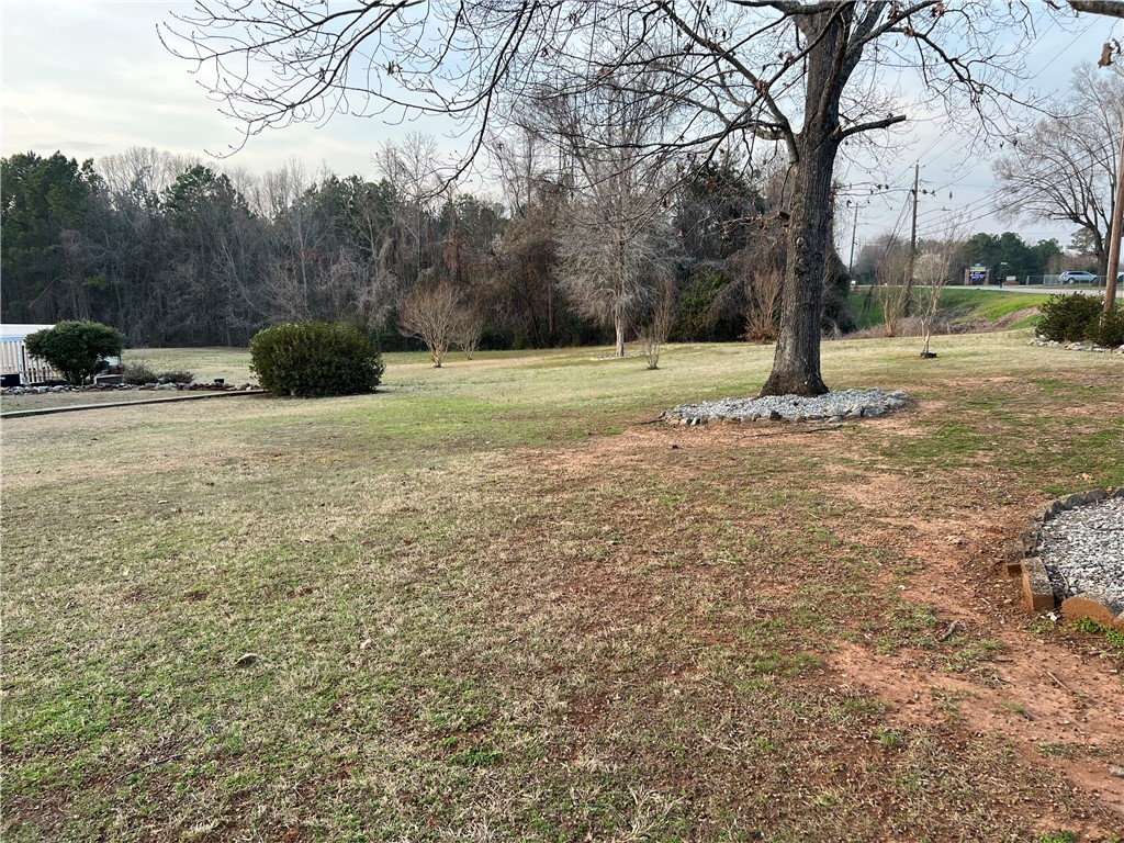 521 Calhoun Shores Parkway Calhoun Falls, SC 29628 - Photo 26 of 39 Expansive green grounds and mature trees create a serene natural landscape.