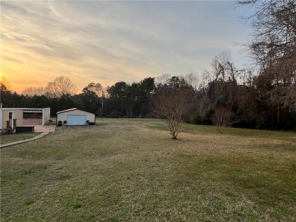 521 Calhoun Shores Parkway Calhoun Falls, SC 29628 - Photo 27 of 39 Expansive outdoor space with a detached garage and shed, offering ample room for various activities.