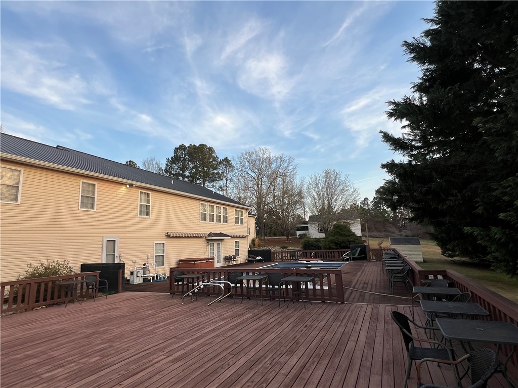 521 Calhoun Shores Parkway Calhoun Falls, SC 29628 - Photo 31 of 39 This spacious backyard features a large deck with an inviting pool, perfect for outdoor enjoyment.