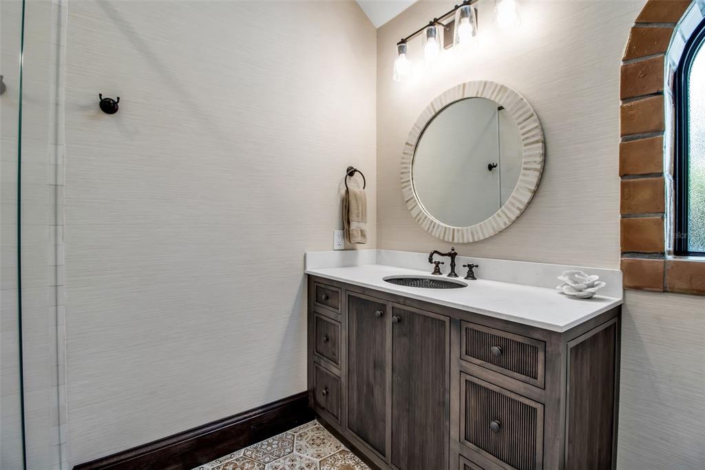 121 North Casey Key Road Osprey, FL 34229 - Photo 37 of 63 a bathroom with a sink and a mirror