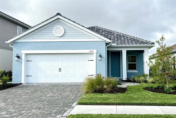a view of a house with a small yard and plants