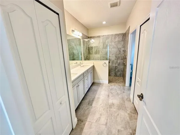 a bathroom with sink a mirror a bathtub and shower