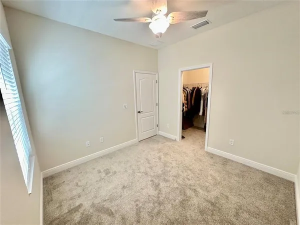 en empty room with fan and entryway