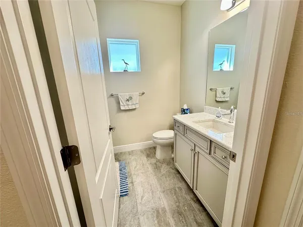 a bathroom with sink a toilet a shower and a mirror