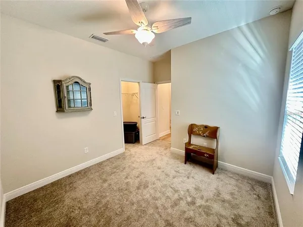 a view of a livingroom with lounge chair and a window