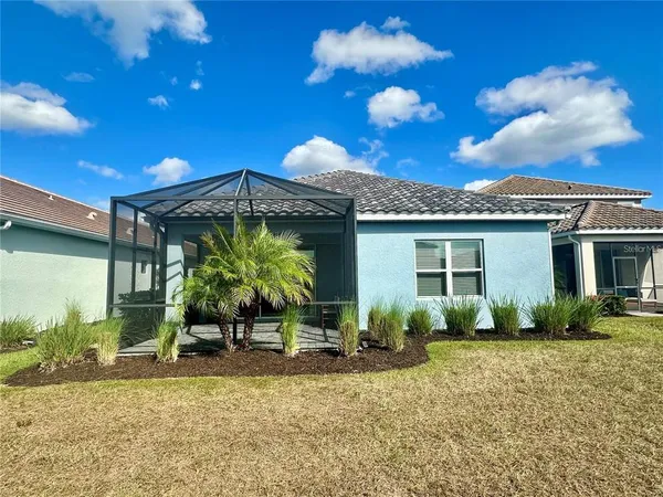 a view of a house with backyard porch and sitting area
