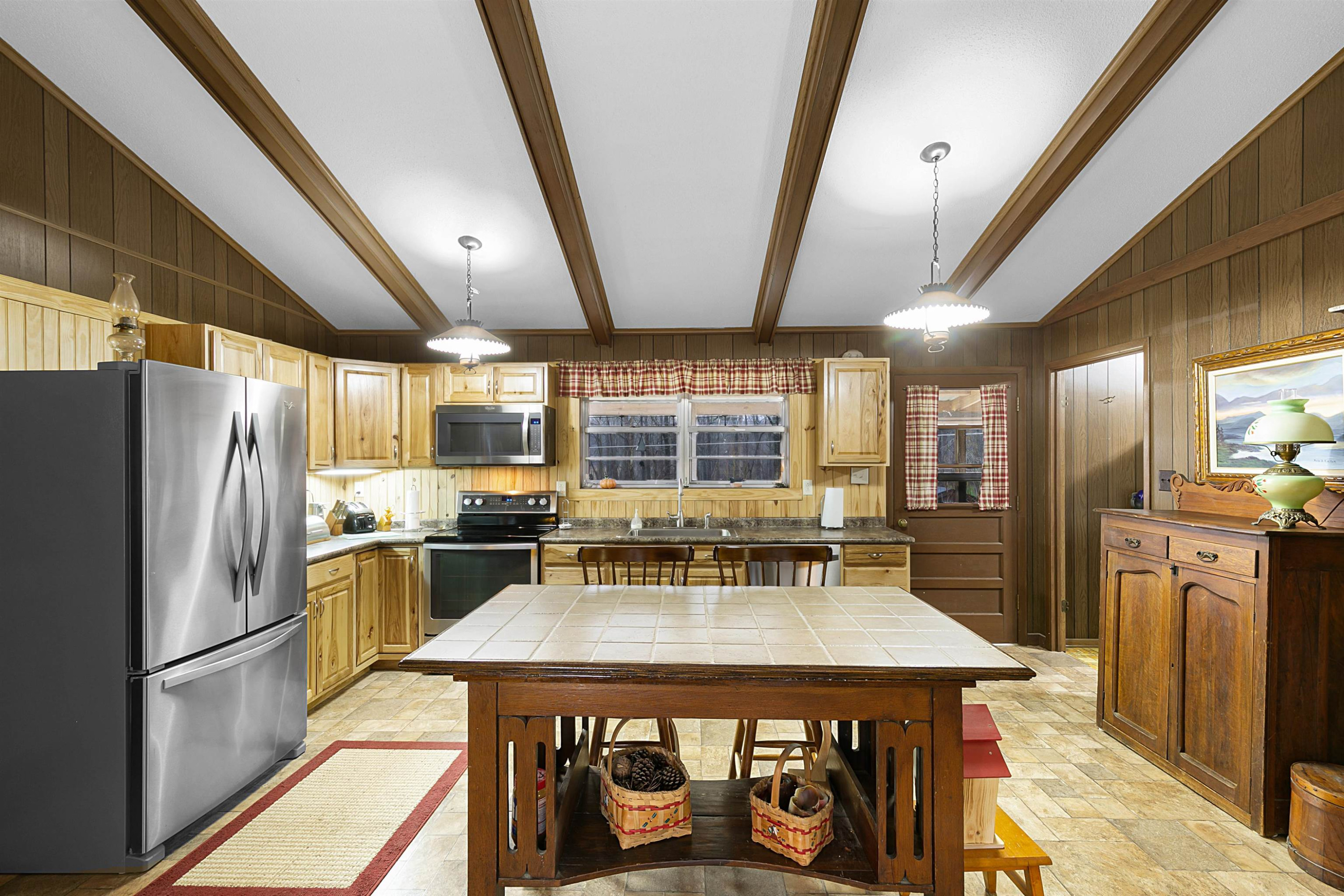121 Odell Road Jackson, TN 38301 - Photo 4 of 18 a kitchen with refrigerator a stove a sink dishwasher and wooden cabinets