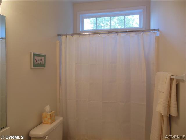 811 Club Ridge Terrace Chester, VA 23836 - Photo 12 of 21 a bathroom with a shower curtain