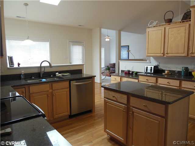 811 Club Ridge Terrace Chester, VA 23836 - Photo 6 of 21 a kitchen with granite countertop a sink a stove and cabinets