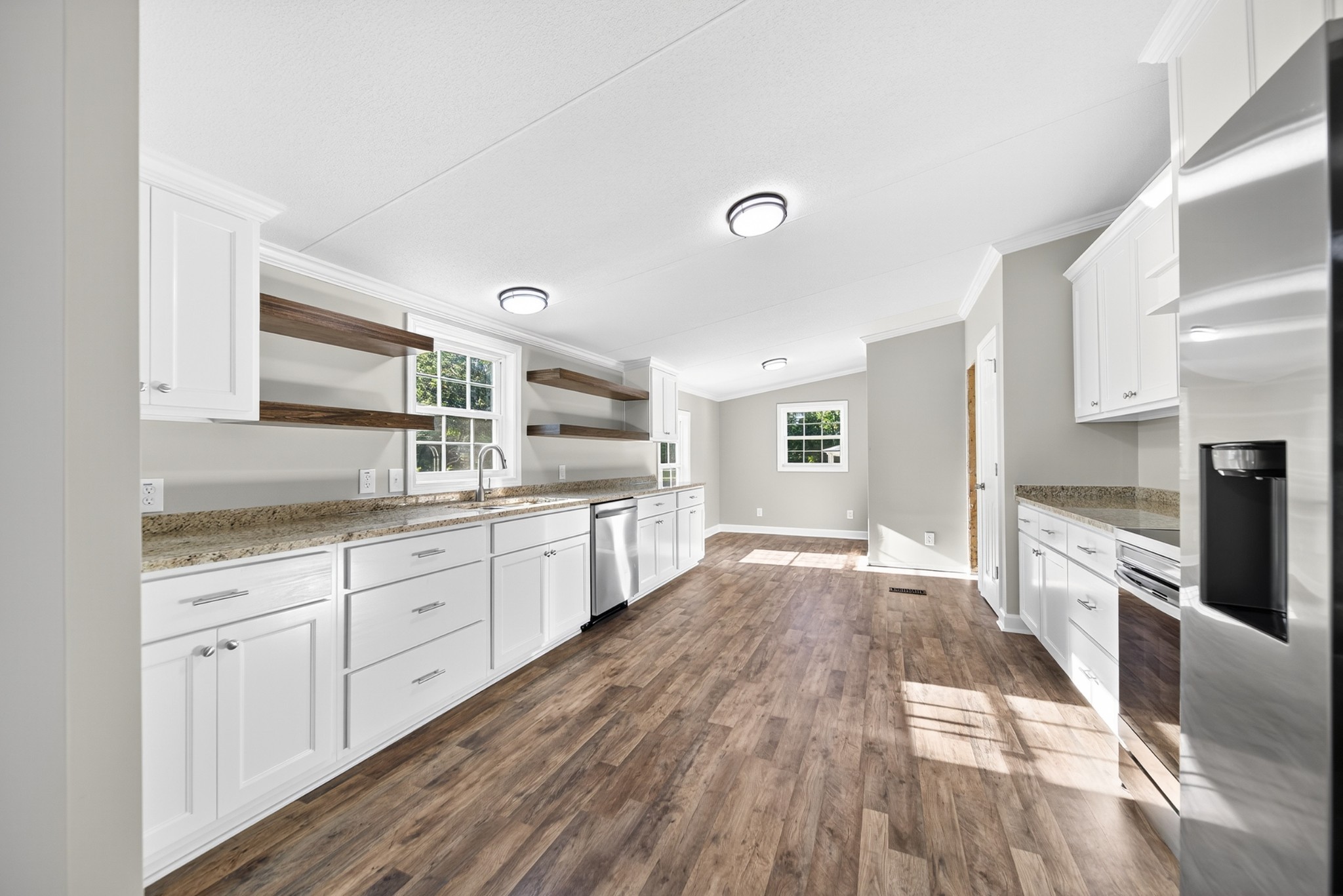 4675 Wills Road Cross Plains, TN 37049 - Photo 29 of 69 a large kitchen with cabinets wooden floor and stainless steel appliances