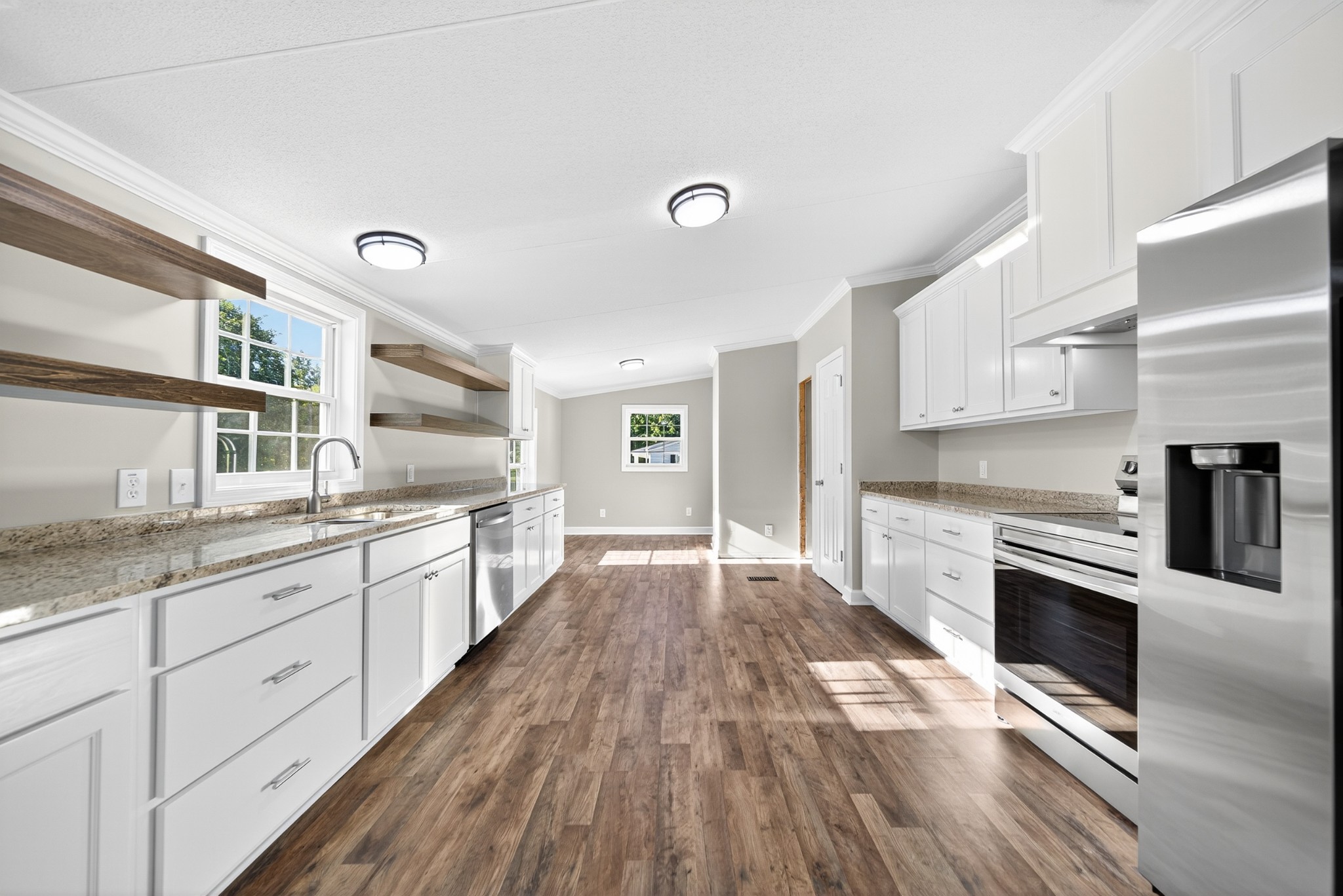 4675 Wills Road Cross Plains, TN 37049 - Photo 30 of 69 a large kitchen with cabinets wooden floor and stainless steel appliances