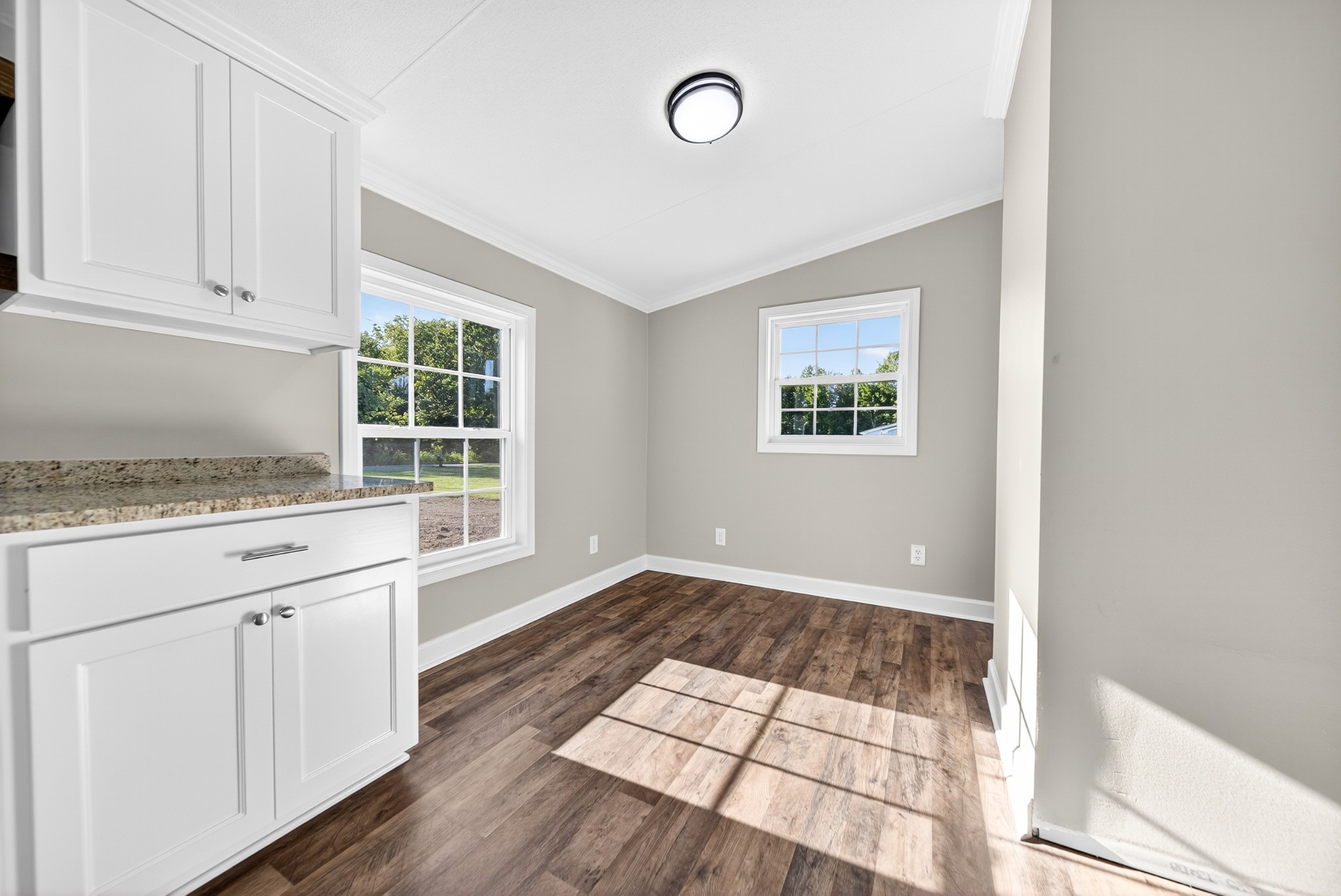 4675 Wills Road Cross Plains, TN 37049 - Photo 33 of 69 an empty room with wooden floor cabinet and windows