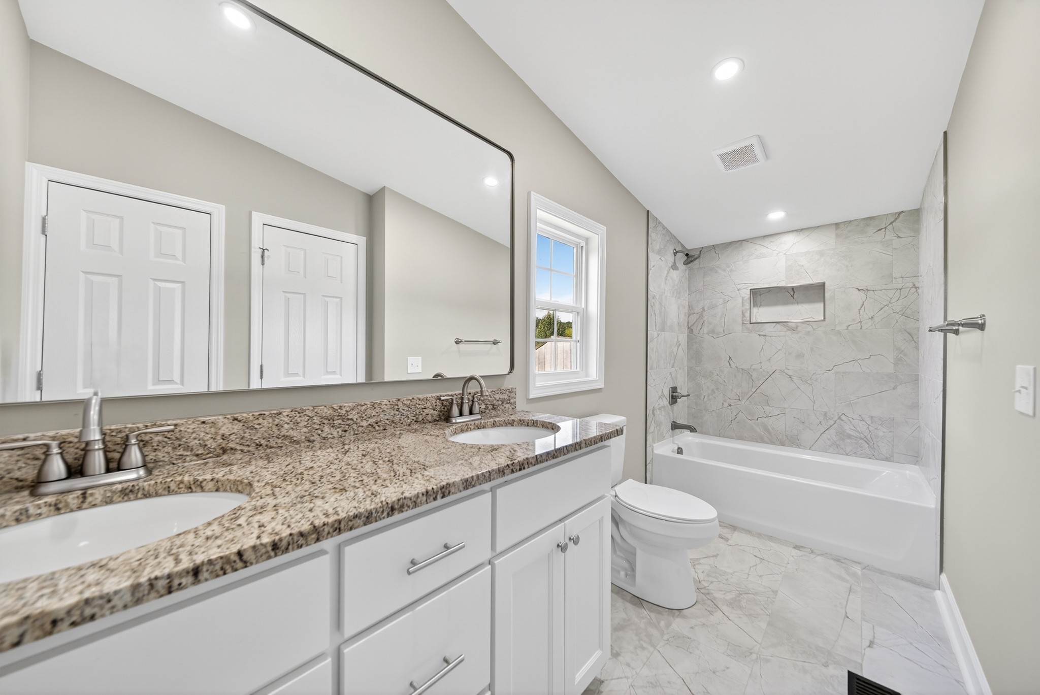 4675 Wills Road Cross Plains, TN 37049 - Photo 39 of 69 a bathroom with a granite countertop sink a toilet a mirror and bathtub