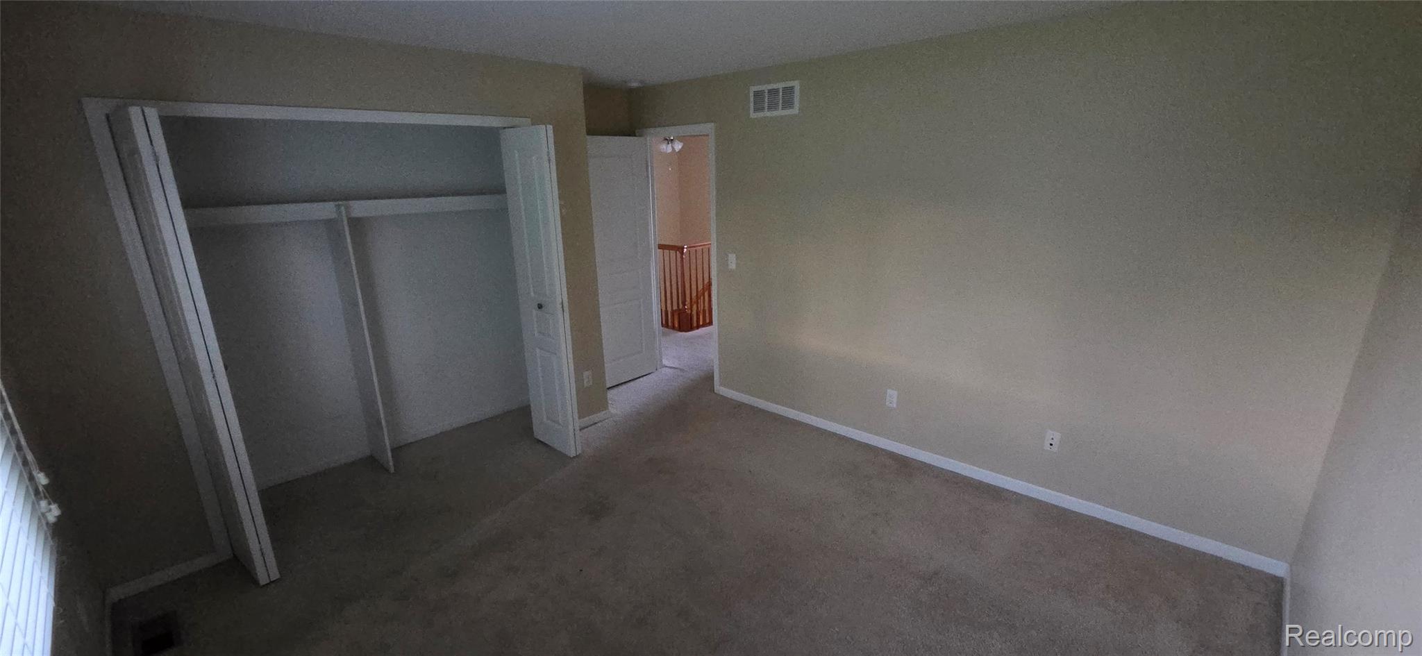 380 Huntington Court Rochester, MI 48307 - Photo 16 of 26 Carpeted room featuring a built-in closet with bi-fold doors