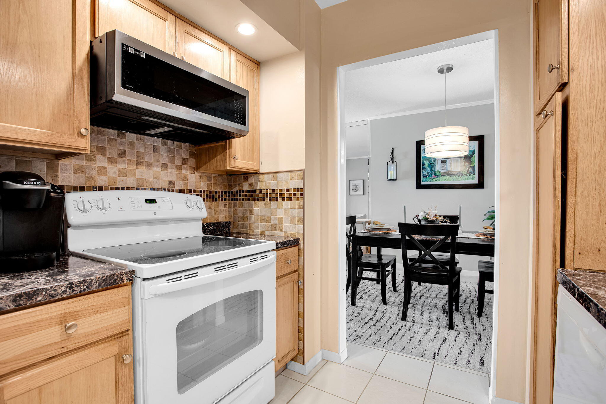 250 Northeast 20th Street, Unit 5240 Boca Raton, FL 33431 - Photo 4 of 49 a kitchen with a stove and a microwave