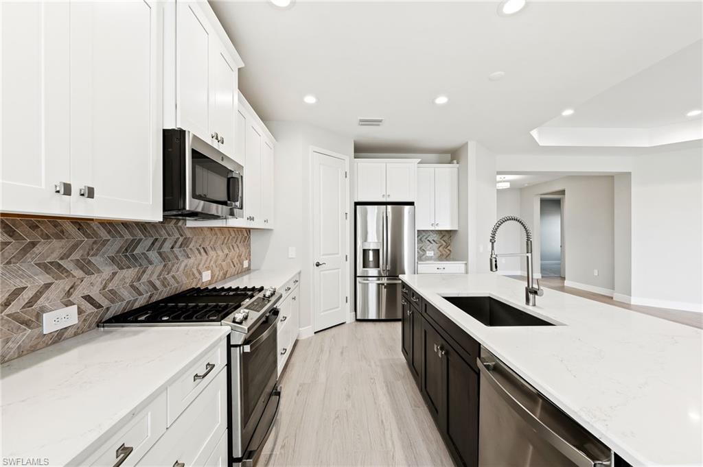 3952 Pegasus Way Naples, FL 34120 - Photo 16 of 50 a kitchen with a sink stove and refrigerator