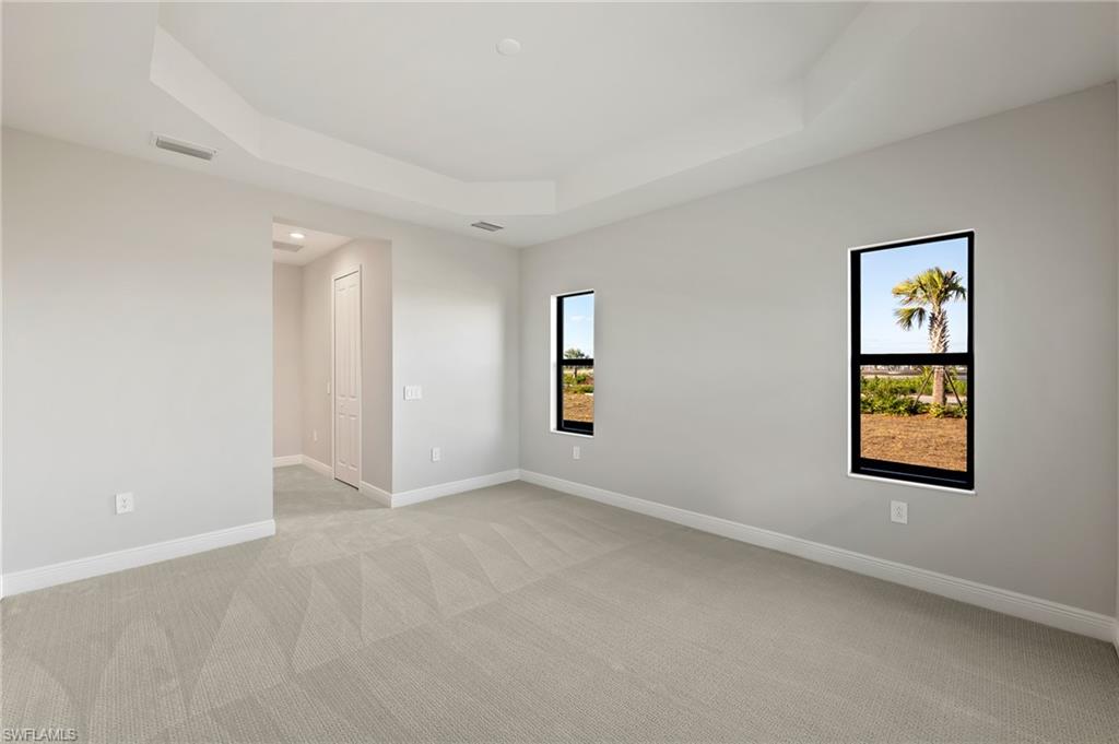 3952 Pegasus Way Naples, FL 34120 - Photo 24 of 50 an empty room with windows and painting on the wall