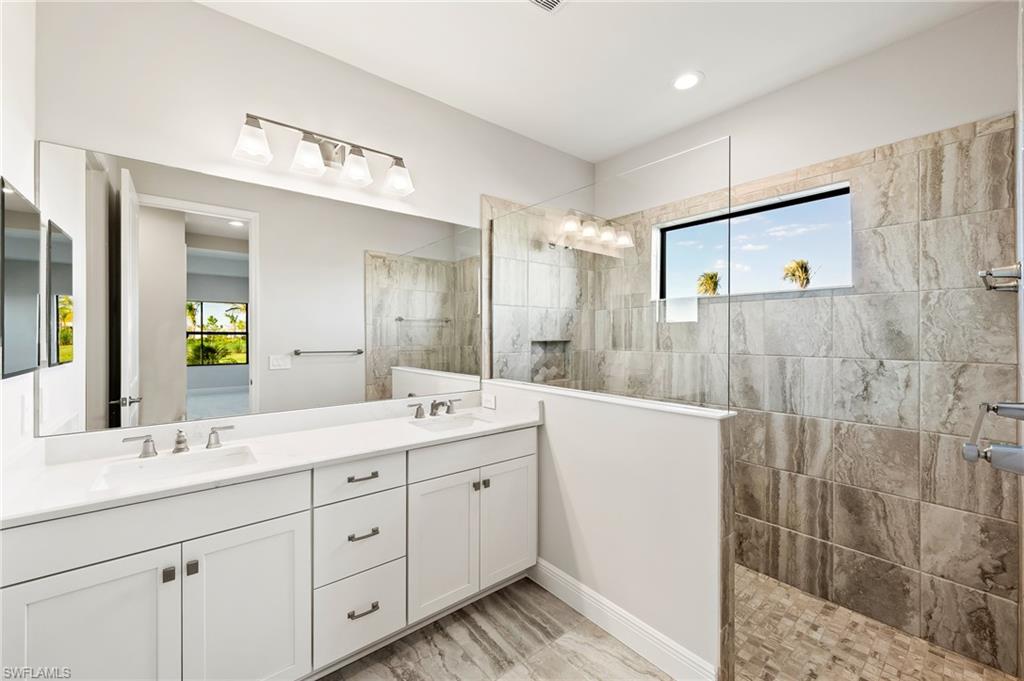 3952 Pegasus Way Naples, FL 34120 - Photo 26 of 50 a bathroom with a double vanity sink mirror and double