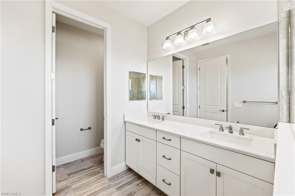 3952 Pegasus Way Naples, FL 34120 - Photo 27 of 50 a bathroom with a double vanity sink and mirror
