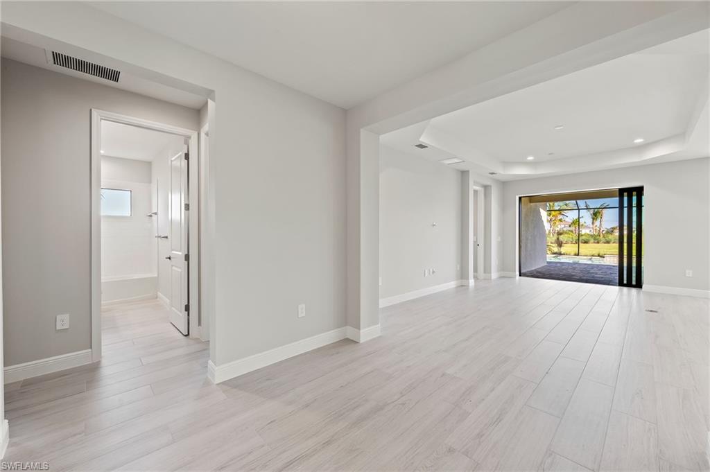 3952 Pegasus Way Naples, FL 34120 - Photo 29 of 50 an empty room with window and wooden floor