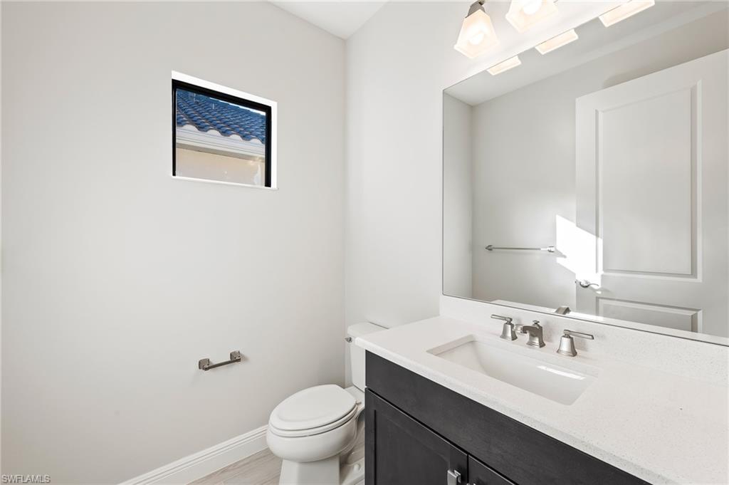 3952 Pegasus Way Naples, FL 34120 - Photo 33 of 50 a bathroom with a toilet a sink and mirror